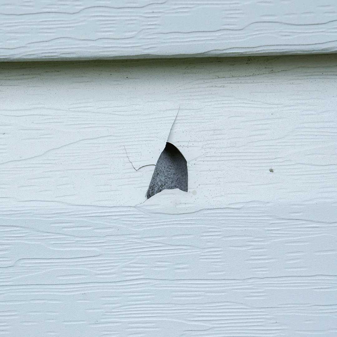 Hail damage to siding of an Omaha home
