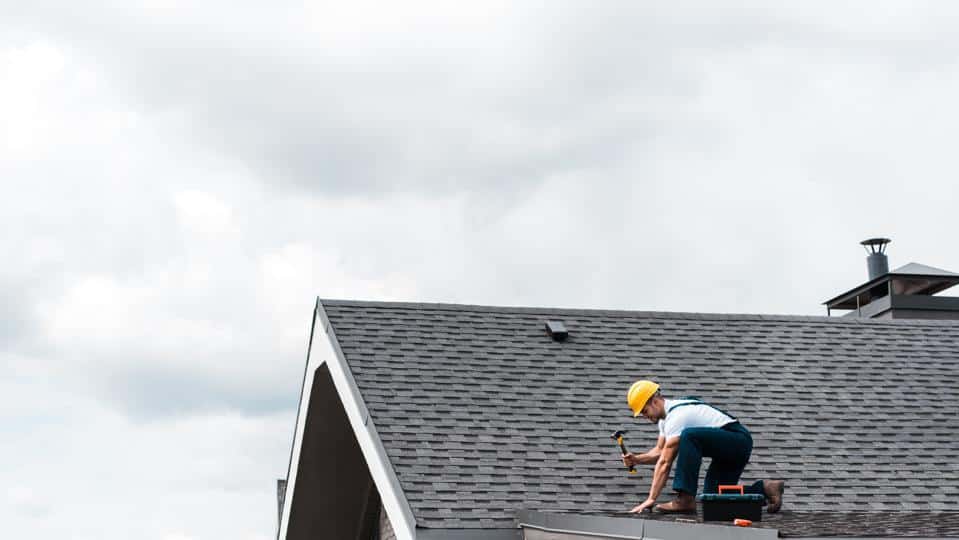 A professional Omaha roofer installing a composite shingle roof.