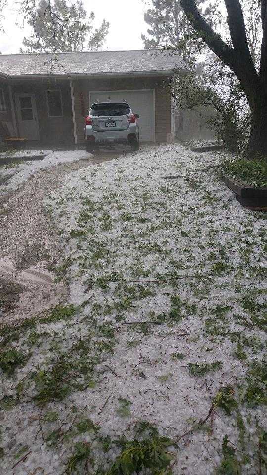 Grass and driveway covered in hail after recent Omaha Hail storm