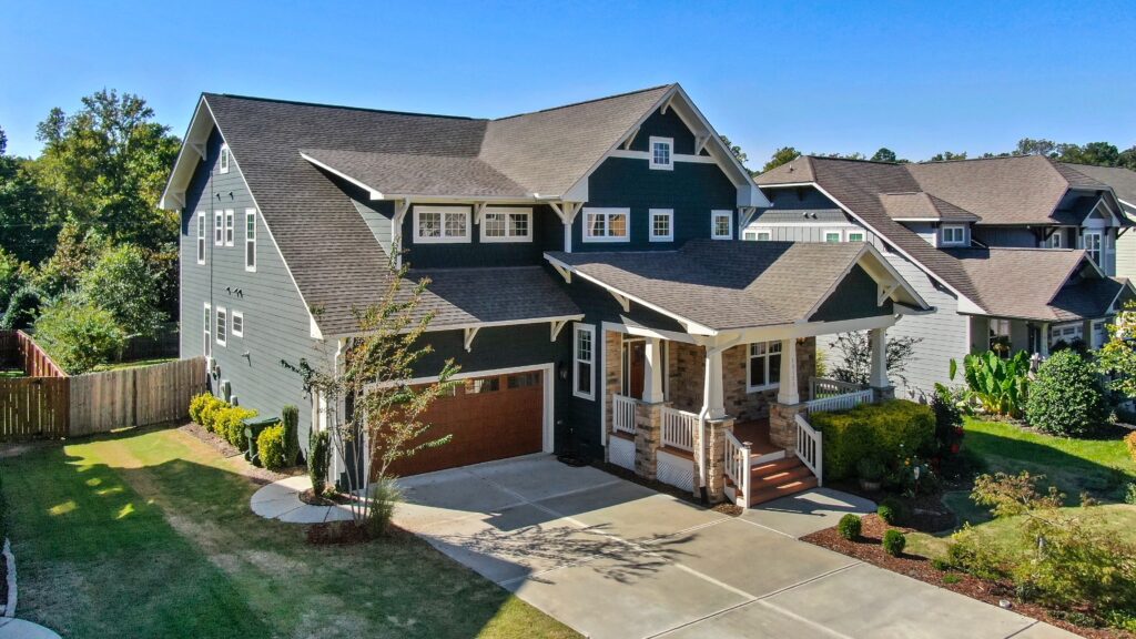 An Omaha home with a brown garage and an asphalt shingle roof.