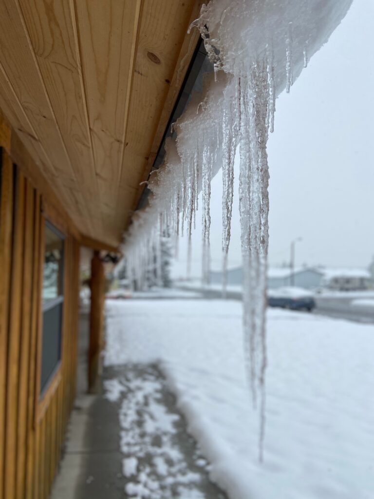 Side view of ice dam build up on Omaha Home in winter