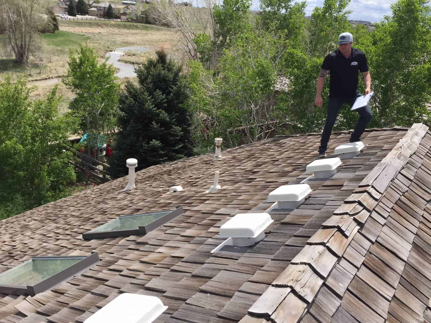 des moines Roof being inspected after hail storm from des moines roofing company