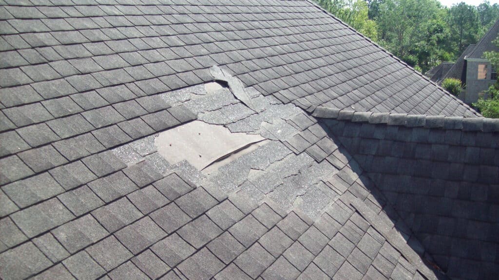 an Omaha shingle roof that is missing some shingles.