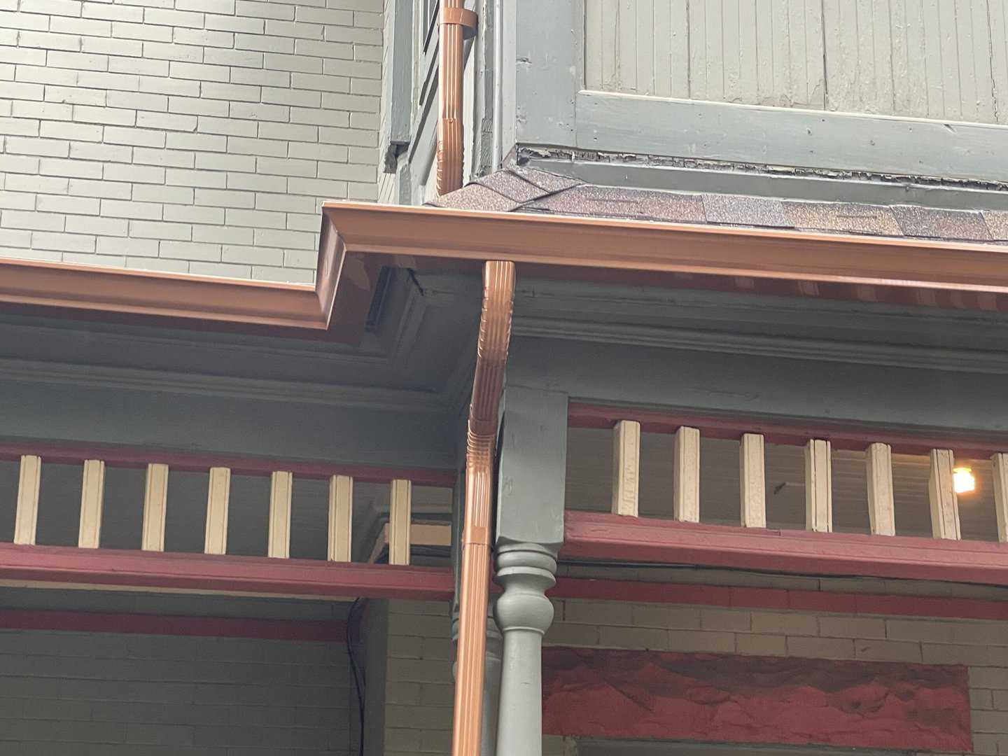 Corner of green house with new copper gutter installation Omaha.