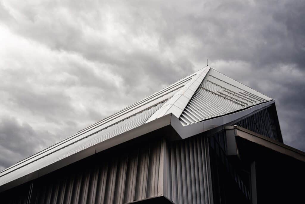 A black and white image of an Omaha home with a metal roof.