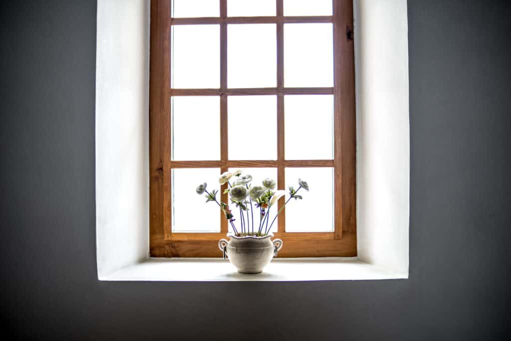 A flower vase in front of a freshly installed house window in an Omaha home.