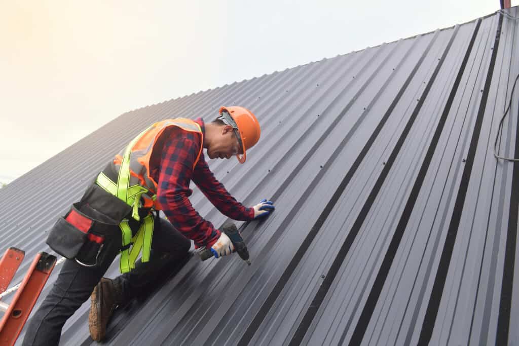 A professional Omaha roofer installing a metal roof.